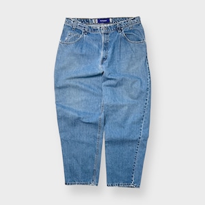 May include: Light blue denim jeans with a relaxed fit. The jeans have a classic five-pocket design, a button and zipper closure, and a small brand tag. The denim has a faded wash, giving it a vintage look. The jeans are a size 81 cm waist.