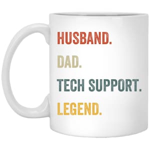 May include: White ceramic coffee mug with the text "Husband. Dad. Tech Support. Legend." in a vintage style font. The text is in different colours, including red, yellow, and blue.