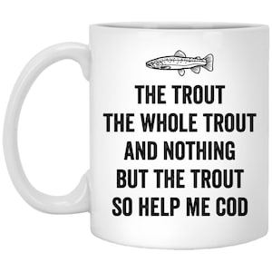 May include: White ceramic coffee mug with a black and white illustration of a trout and the text "The Trout The Whole Trout And Nothing But The Trout So Help Me Cod".