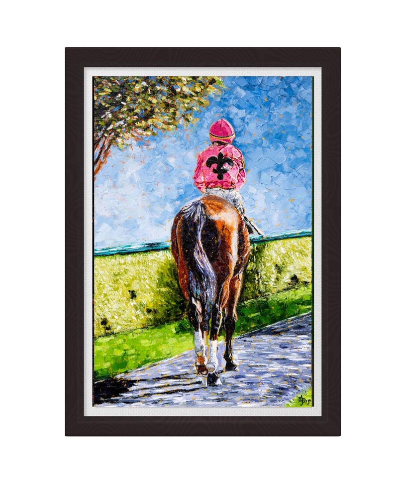 May include: Oil painting of a racehorse and jockey framed in a dark wood frame. The jockey wears a pink cap and jacket with a black fleur-de-lis. The horse is brown and white, walking on a paved path with green grass and a blue sky background.