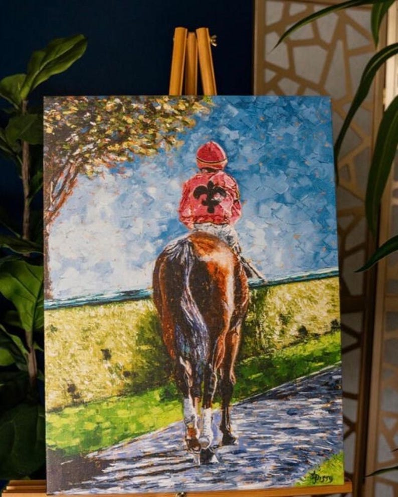 May include: An oil painting on canvas depicts a jockey on a brown horse, viewed from behind. The jockey wears a red jacket with a black emblem and a red cap. The background shows a blue sky, a green field, and a tree.