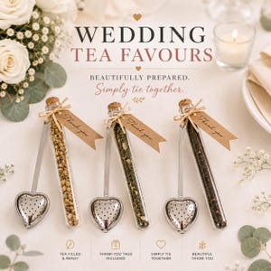May include: Three glass test tubes filled with loose leaf tea, each paired with a silver heart-shaped tea infuser and a brown paper tag printed with the words Thank you. The tubes are sealed with cork stoppers and tied with twine.