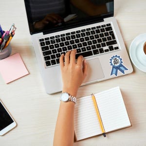a person is typing on a laptop computer