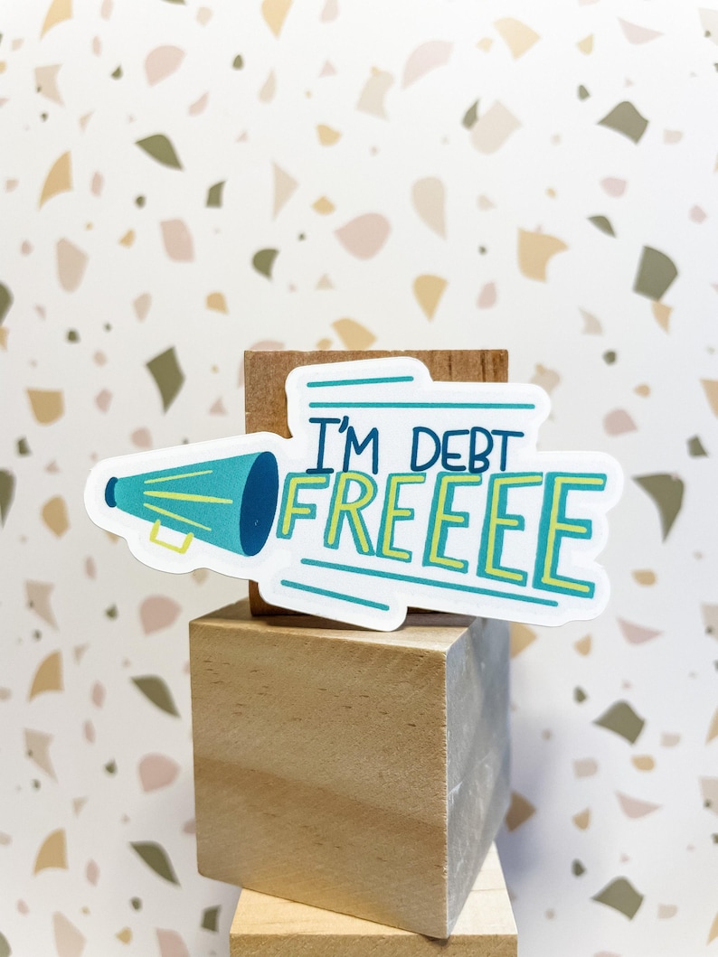 vinyl waterproof sticker that says i'm debt free in white green and yellow perfect for debt free party favors