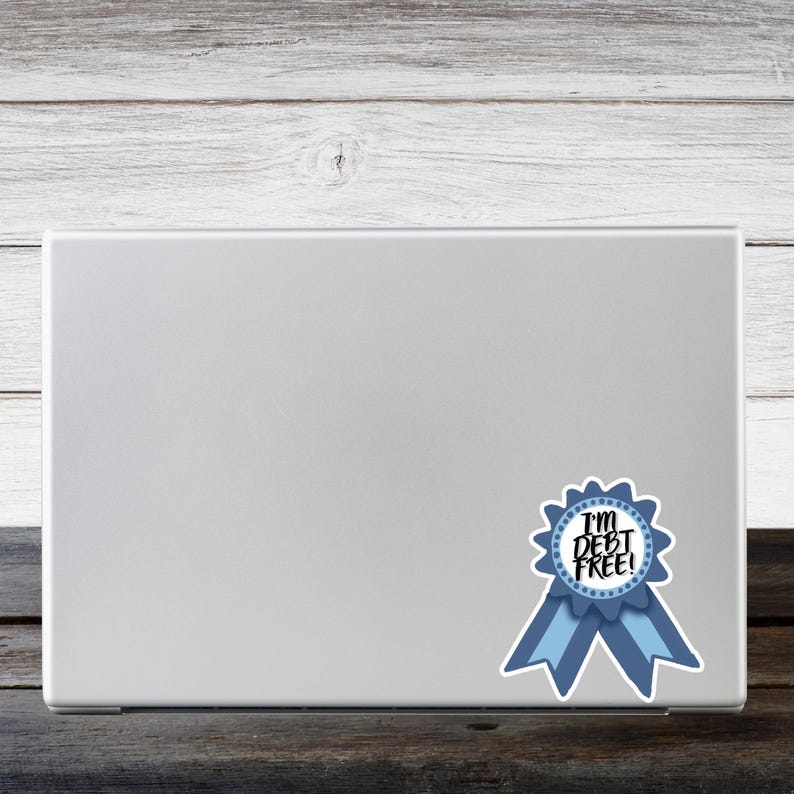 a laptop computer with a blue ribbon sticker on it