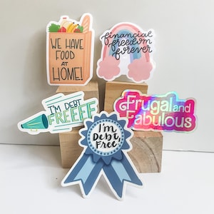 a bunch of stickers sitting on top of a wooden block