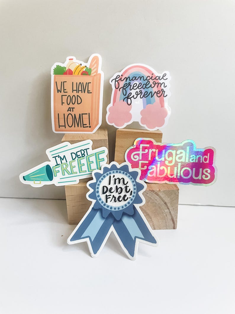 a bunch of stickers sitting on top of a wooden block