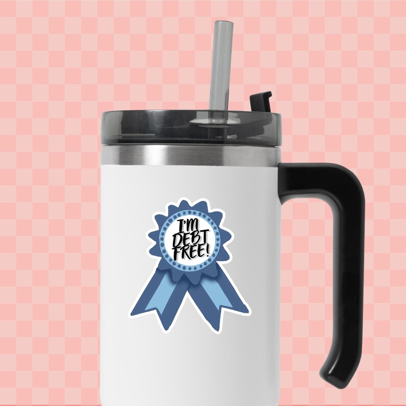 a white and black coffee mug with a blue ribbon around it