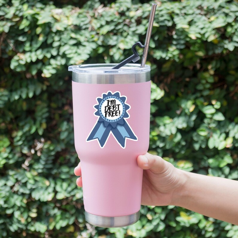 a person holding a pink cup with a straw in it