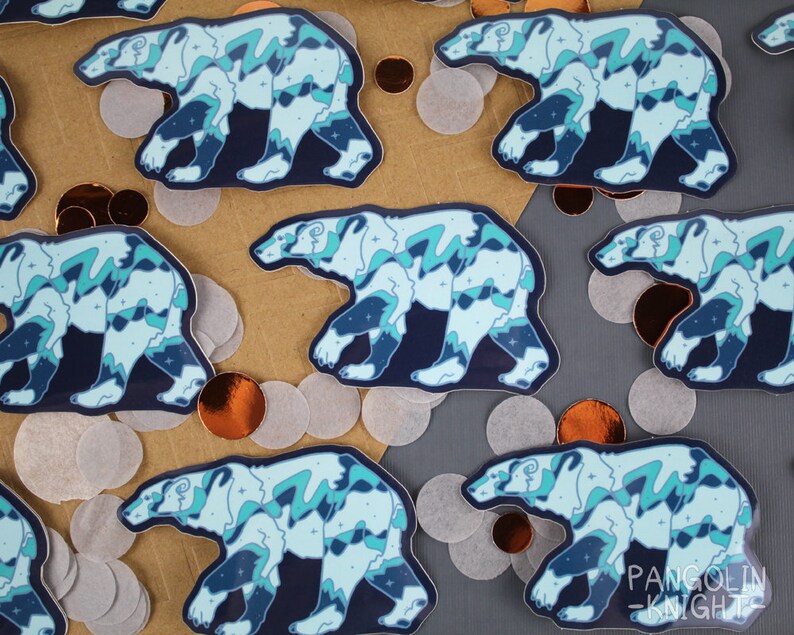May include: Multiple blue and white polar bear stickers with a starry night sky design. The stickers are on a brown and gray background.