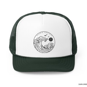 Pu&ograve; includere: Cappellino da camionista verde scuro e bianco con una grafica circolare di onde oceaniche, uccelli e un sole, con la scritta "SUNNIE SOCIETY". Il cappellino ha un retro in rete e una visiera curva.