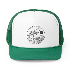 Pu&ograve; includere: Cappellino da camionista verde e bianco con una grafica circolare di onde, un sole e uccelli. Il testo "SUNNIE SOCIETY" &egrave; sopra la grafica. Il cappellino ha una visiera verde e un retro in rete.