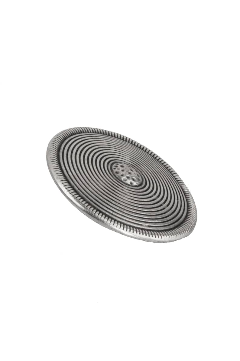 May include: A silver-toned metal button with a circular design featuring concentric circles and a textured center.