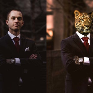 May include: A man in a black suit with a red tie and a white pocket square. He is wearing a watch on his left wrist. The man has a leopard's head in place of his own.
