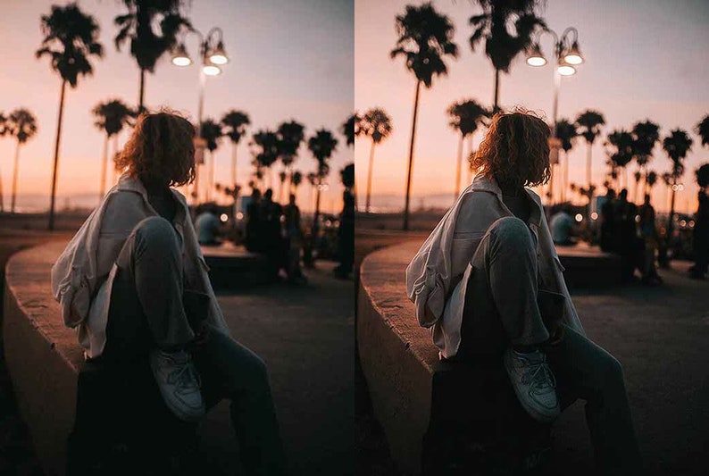 May include: A person wearing a white jacket and blue jeans sits on a concrete ledge. The person is looking to the right. The background is a sunset with palm trees and streetlights.