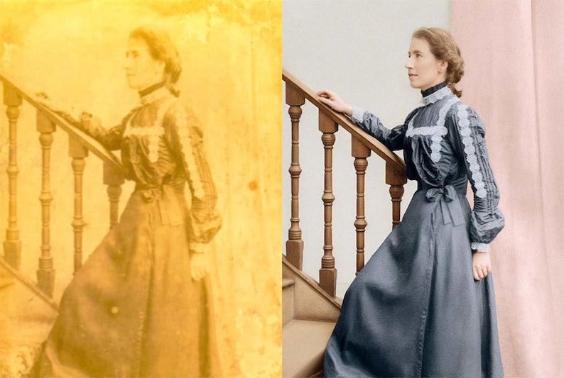 May include: A vintage photograph of a person in a long, dark dress with white lace trim, standing on a wooden staircase. The dress has long sleeves and a high collar. The staircase has a wooden handrail and balusters.