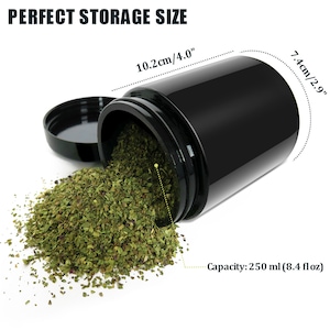 May include: A black plastic jar with a lid, spilling out green dried herbs. The jar is labelled with the text "PERFECT STORAGE SIZE" and measurements in centimetres and inches. The text "Capacity: 250 ml (8.4 fl oz)" is also visible.
