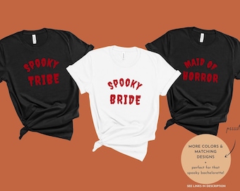 May include: Three black t-shirts with white text. The shirts say "Spooky Tribe", "Spooky Bride", and "Maid of Horror".