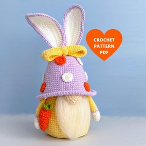 May include: Crochet pattern PDF for a purple and yellow gnome wearing a bunny hat with a yellow bow. The gnome is holding a carrot and has a white beard.