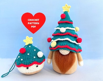 May include: Two crocheted Christmas tree ornaments. One is a small tree with a white face and the other is a larger tree with a gnome face and a red beard. Both trees are green with red and white accents.