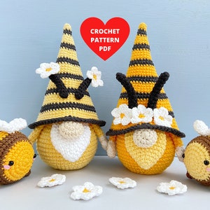 May include: Two crocheted bee gnomes with black and yellow striped hats and white flower accents.  Two smaller crocheted bees are also included.  The image includes the text "CROCHET PATTERN PDF".