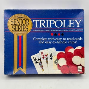 May include: A blue Cadaco Senior Series Tripoley board game box featuring a gold ribbon graphic, playing cards showing a queen, king, and ace, and a pile of red and white circular game chips. The text reads The Original Game of Michigan Rummy, Hearts & Poker.
