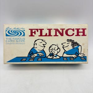 May include: A rectangular white box for the Flinch card game by Parker Brothers. The box features red text reading FLINCH and a blue illustration of three people playing a card game at a blue table. The Parker Brothers logo is in the top left.