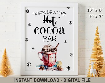 May include: A framed white sign featuring the black text WARM UP AT THE Hot cocoa BAR with black snowflake illustrations and a watercolor graphic of a mug filled with hot cocoa, whipped cream, and a straw. Dimensions are 10 inches by 8 inches.