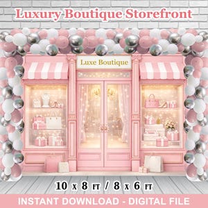May include: A pink storefront backdrop with the text "Luxury Boutique Storefront" and "Luxe Boutique". The storefront has a pink awning, glass display windows, and is decorated with balloons in pink, white, and silver. The backdrop is 10 x 8 ft or 8 x 6 ft.