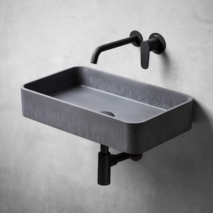 May include: A black rectangular bathroom sink with a black faucet and drain. The sink is mounted on a wall.