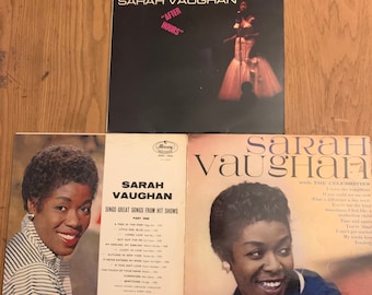 May include: Three vintage vinyl records by Sarah Vaughan. The first record is titled "After Hours" and features a black and white photo of Sarah Vaughan in a white dress. The second record is titled "Sarah Vaughan Sings Great Songs From Hit Shows" and features a color photo of Sarah Vaughan. The third record is titled "Sarah Vaughan with the Celebrities" and features a color photo of Sarah Vaughan.