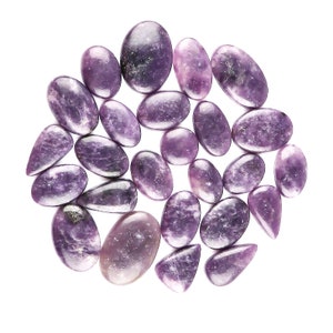 May include: A collection of 20 purple and lavender lepidolite tumbled stones. The stones are smooth and polished, with a variety of shapes and sizes.