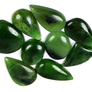 May include: A collection of nine green jade cabochons, some with a teardrop shape and others with a round shape.