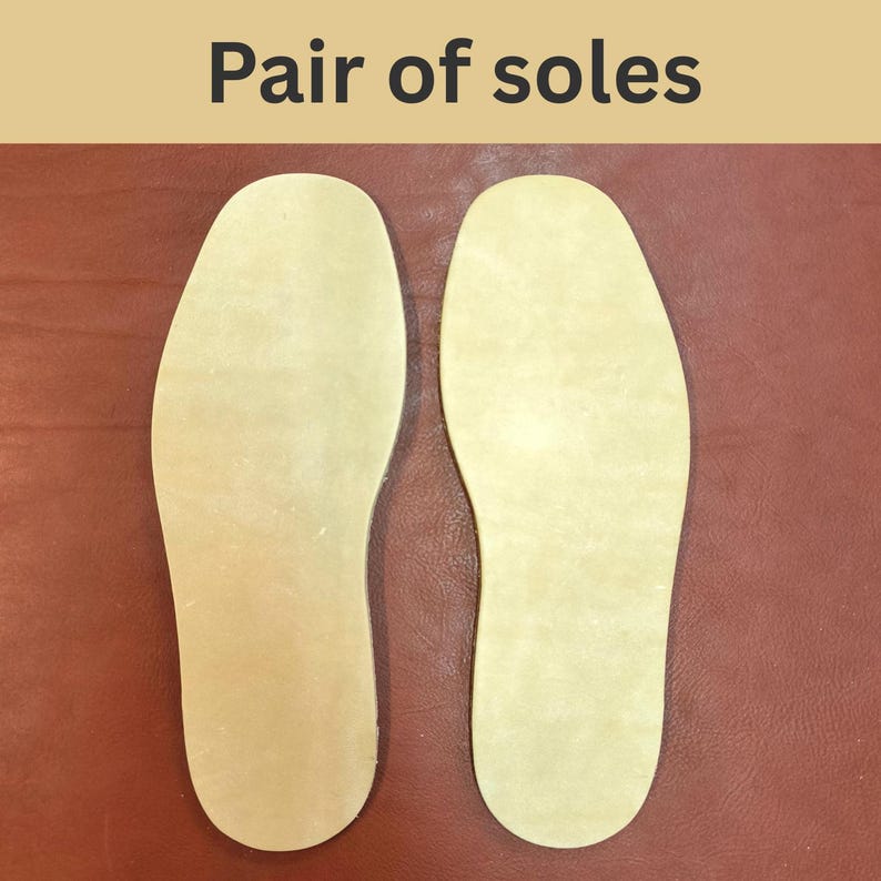 May include: A pair of light beige shoe soles, with the text "Pair of soles" at the top. The soles are placed on a reddish-brown surface. The soles are shaped to fit the bottom of a foot.