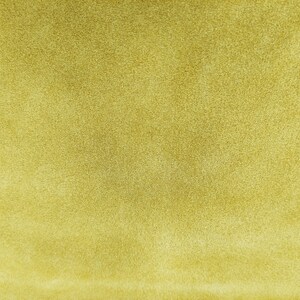 May include: A close-up of a textured, light yellow fabric. The fabric has a soft, fuzzy texture.