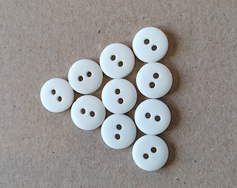 White small round plastic buttons with 2 holes, pack of 100 pieces