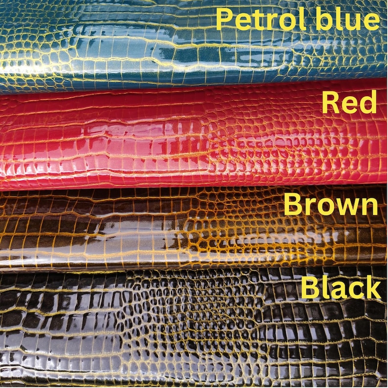 May include: Four swatches of faux leather in different colors: petrol blue, red, brown, and black. Each swatch has a crocodile-embossed pattern.