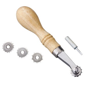 May include: A wooden-handled leather crafting tool with a replaceable metal wheel for creating decorative stitching. The tool comes with three additional wheels of different sizes.