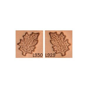 May include: Two leather stamps with a detailed oak leaf design. The stamps are labeled L930 and L929.