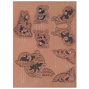 May include: A collection of intricately carved leather pieces in various floral and scroll designs. The pieces are in shades of brown and tan, with dark accents. Each piece is labeled with a unique code, such as "U2730" and "A104".