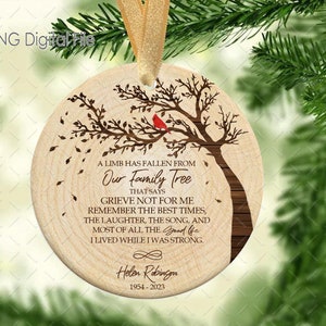 May include: A wooden Christmas bauble featuring a brown tree and a red cardinal. The ornament includes the text "A limb has fallen from our family tree that says grieve not for me remember the best times, the laughter, the song, and most of all the good life I lived while I was strong." and "Helen Robinson 1954-2023".