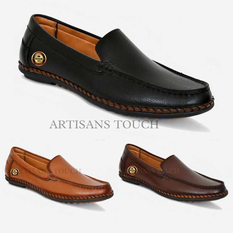 May include: Three pairs of leather loafers in black, brown, and tan. The loafers have a stitched edge and a small gold logo on the side. The text "ARTISANS TOUCH" is printed below the black loafers.