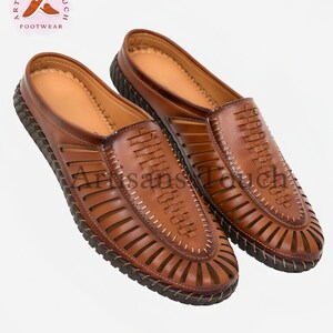 May include: A pair of brown leather sandals with a woven design and a closed toe. The sandals have a slip-on style and a comfortable look.
