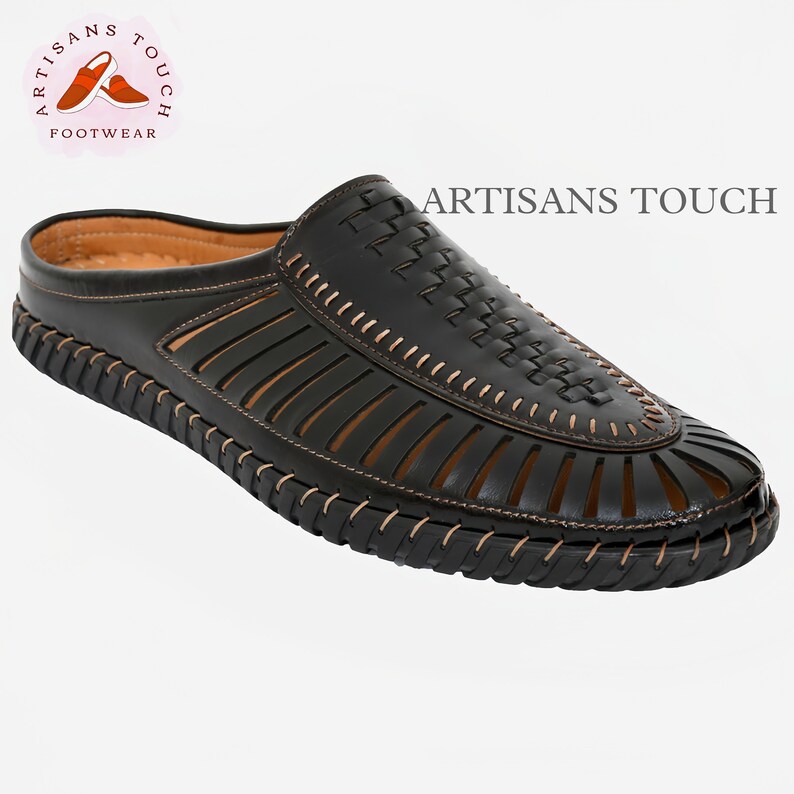 May include: Black leather slip-on sandals with a woven design and brown stitching. The sandals have a closed toe and an open heel. The brand name "ARTISANS TOUCH" is printed on the top of the sandal.
