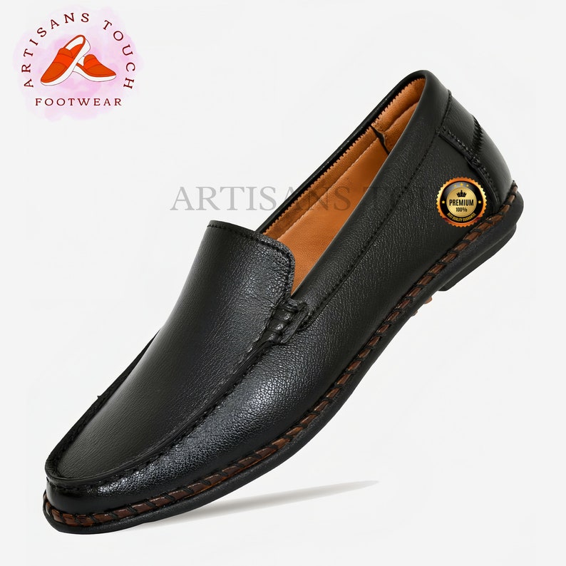 May include: Black leather slip-on shoes with a brown stitched trim and a brown leather insole. The shoes have a 'Premium 100%' label on the side.