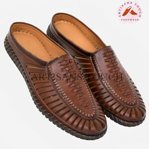 May include: A pair of brown leather sandals with a woven design and cutouts. The sandals have a closed toe and a slip-on style.