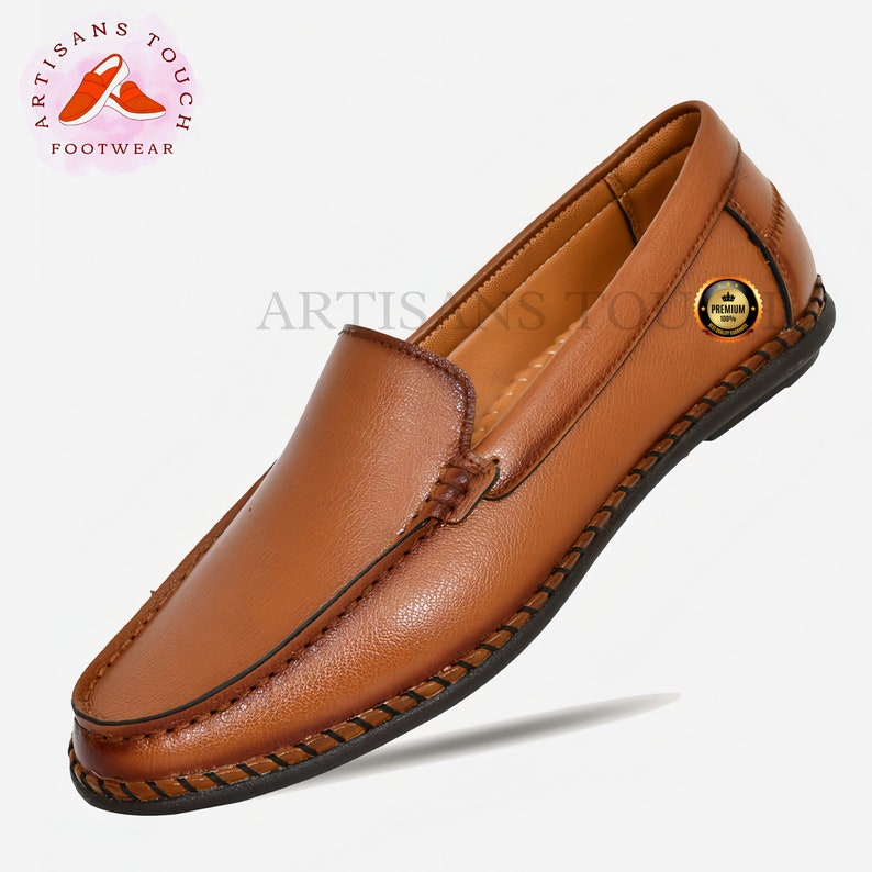 May include: A brown leather loafer with a stitched edge and a black sole. The shoe has a simple design and is made of high-quality leather.