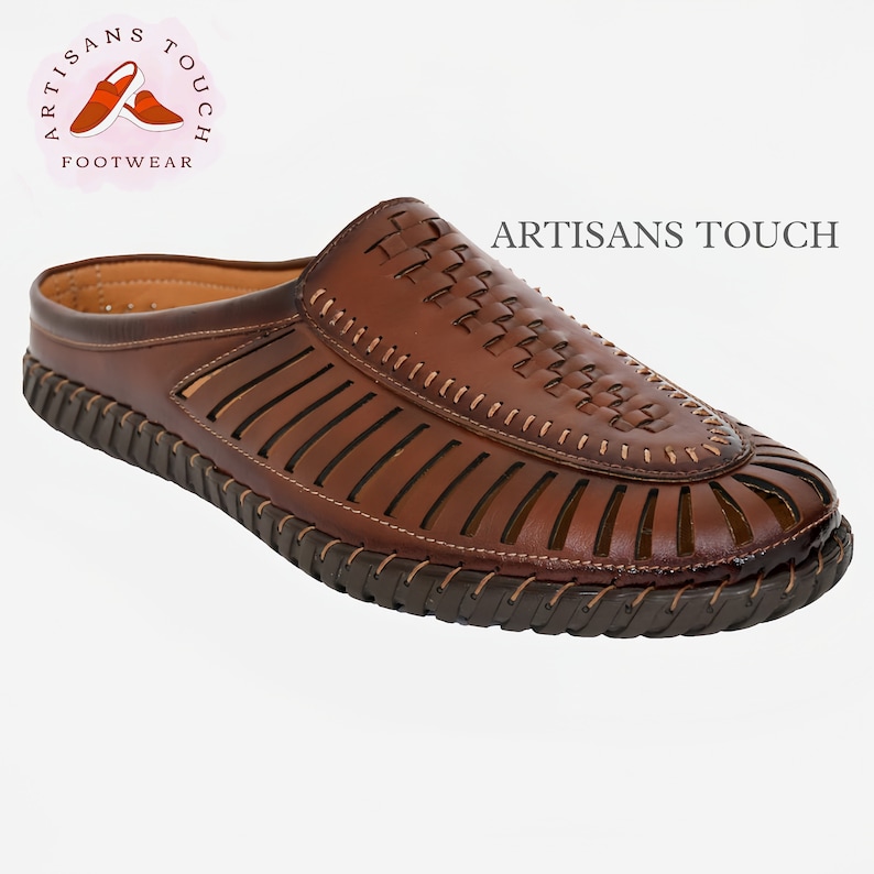 May include: Brown leather slip-on sandals with a woven design and a stitched edge. The sandals have a brown rubber sole and are made by Artisans Touch Footwear.