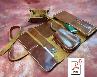 May include: A brown leather roll-up case with multiple compartments for tools or supplies. The case has a strap and a small, square, brown leather tray.