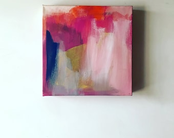 May include: Abstract painting on canvas with pink, red, orange, yellow, blue, and grey brushstrokes.
